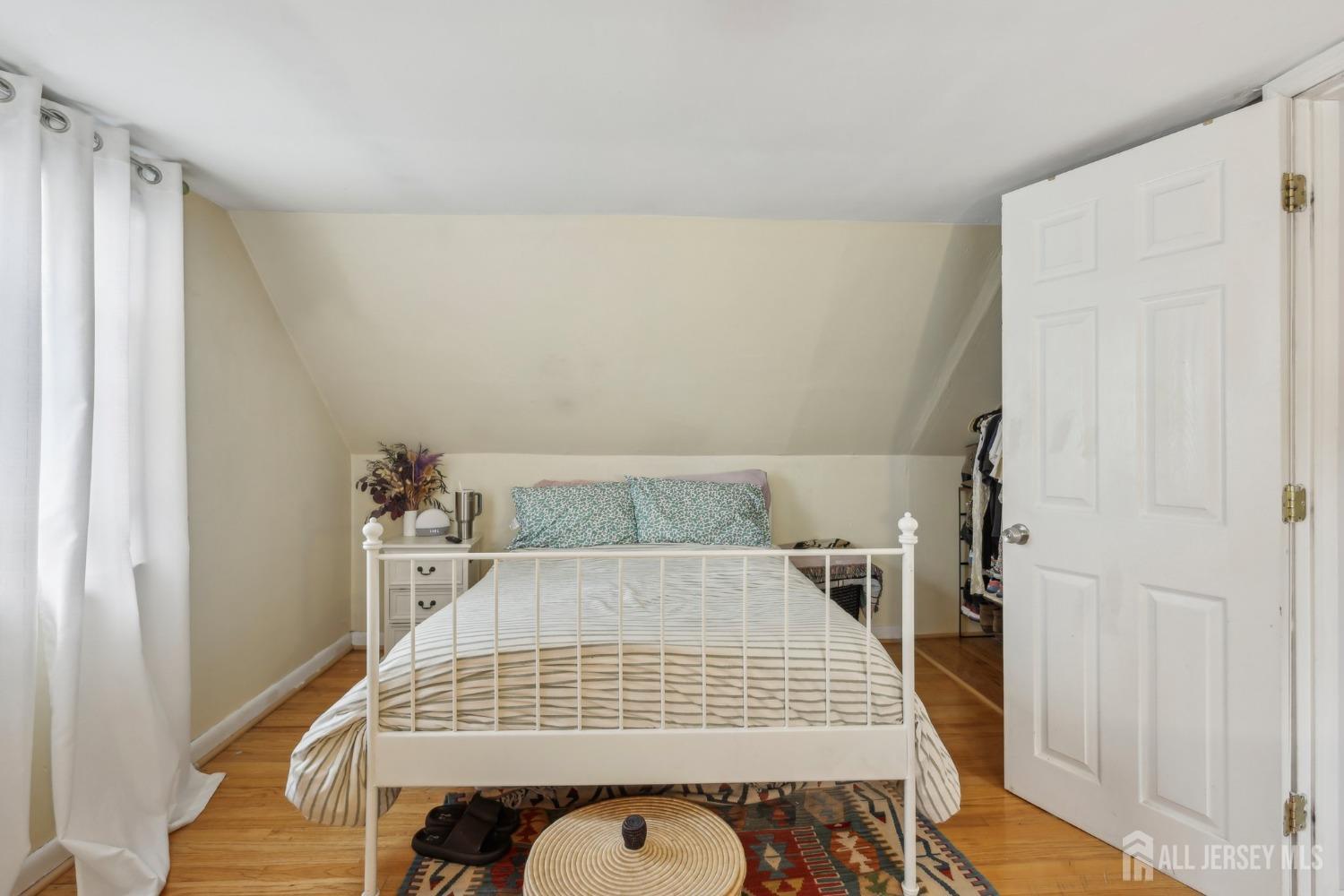 153 East Hill Road Colonia, NJ 07067 - Photo 14 of 40 a bedroom with a bed and wooden floor