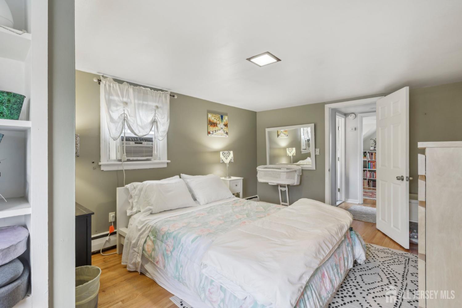 153 East Hill Road Colonia, NJ 07067 - Photo 16 of 40 a bedroom with a bed and a painting on the wall