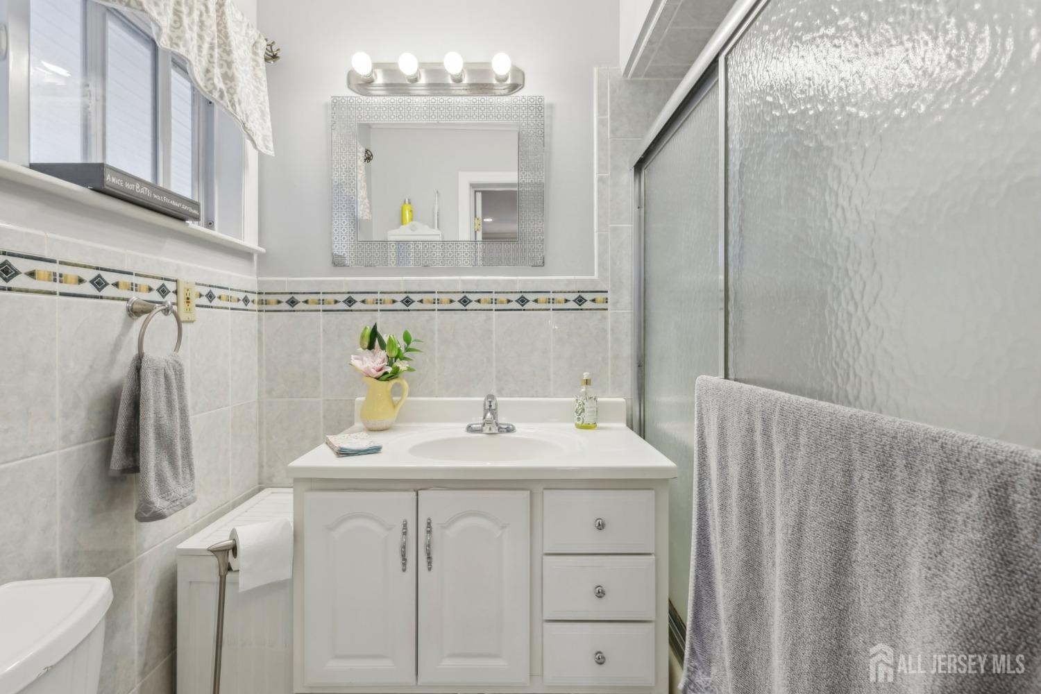 153 East Hill Road Colonia, NJ 07067 - Photo 20 of 40 a bathroom with a sink a toilet and mirror