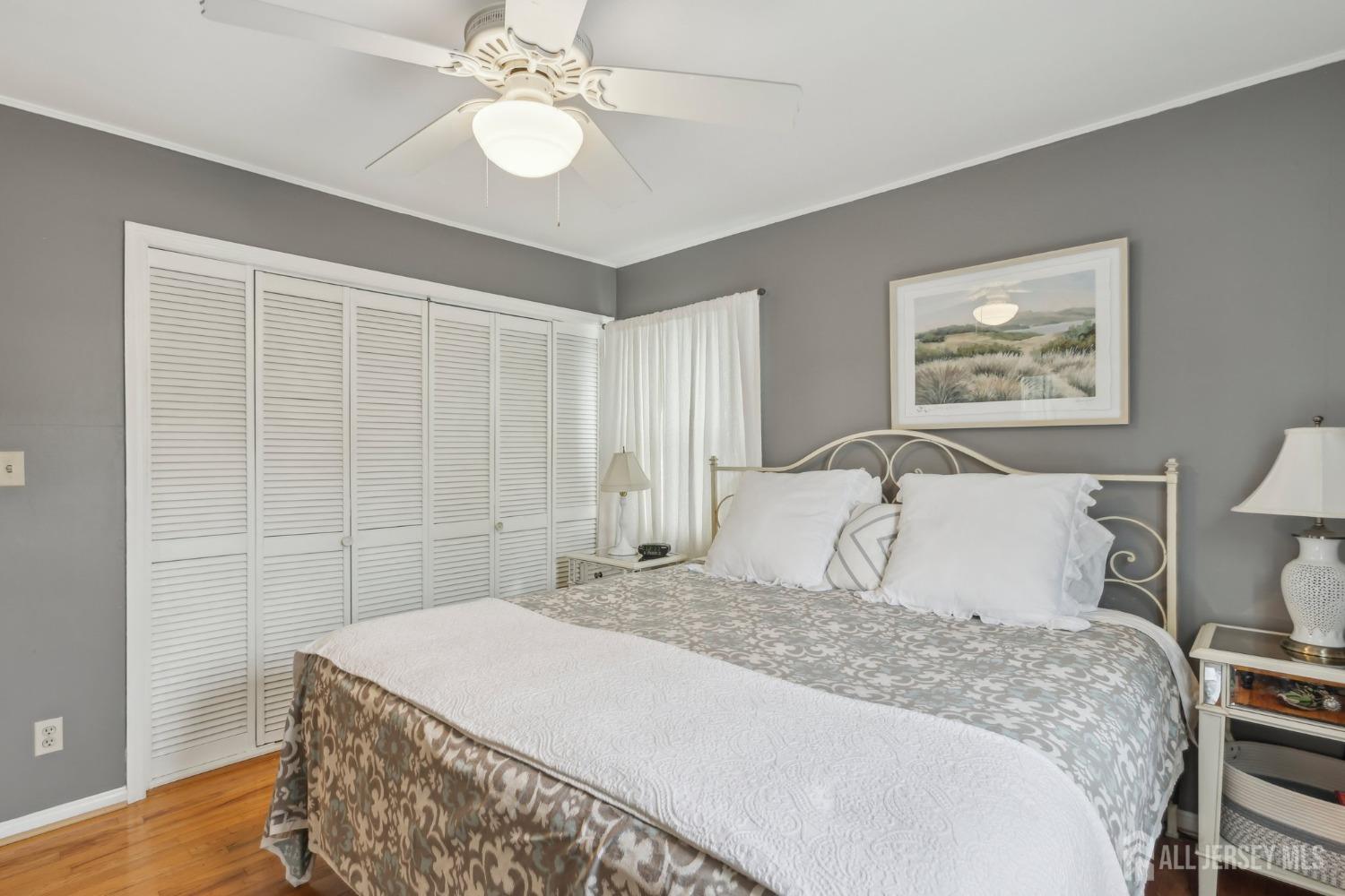 153 East Hill Road Colonia, NJ 07067 - Photo 24 of 40 a spacious bedroom with a bed and a chandelier