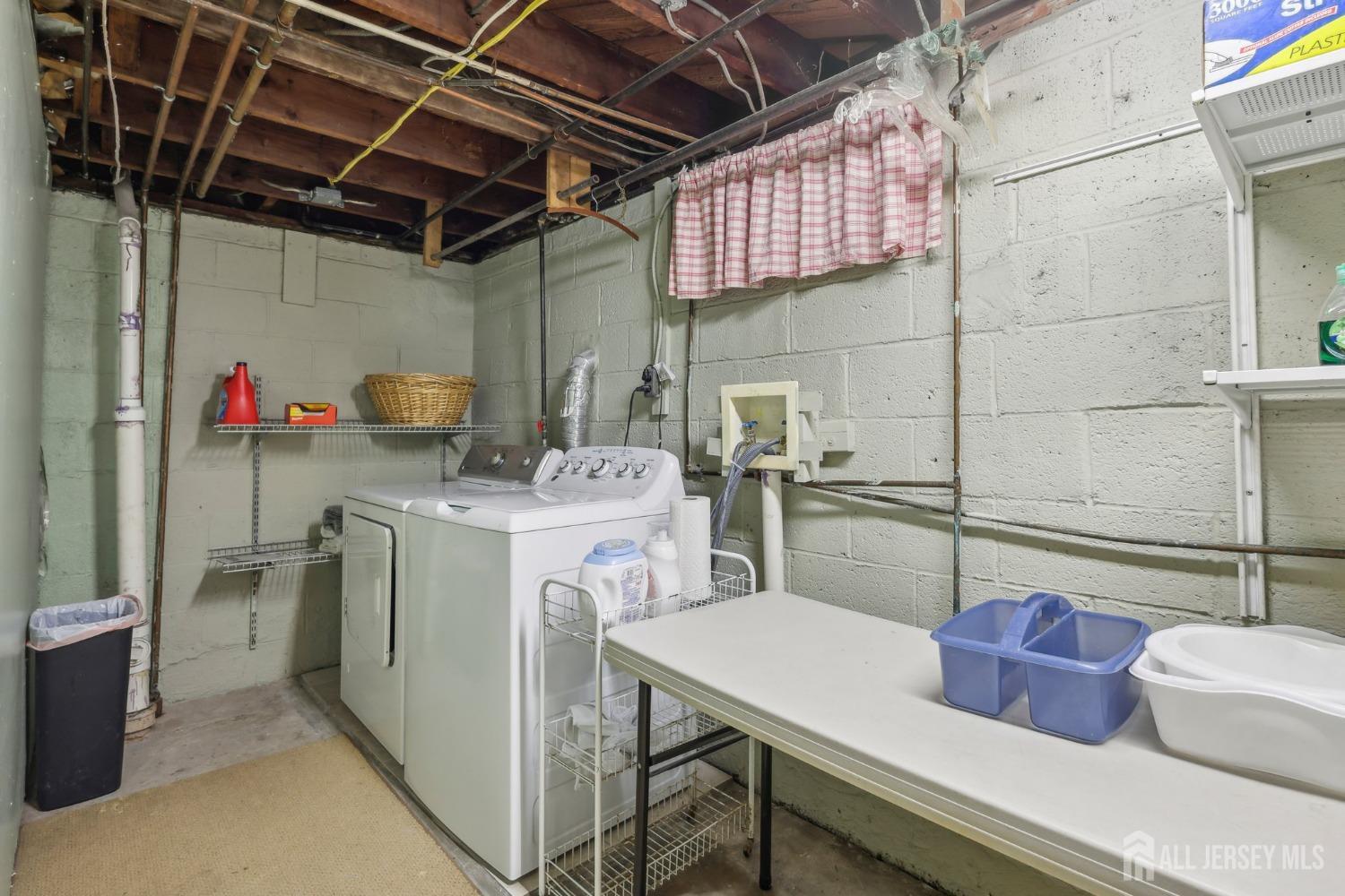 153 East Hill Road Colonia, NJ 07067 - Photo 25 of 40 a storage room with washer and dryer