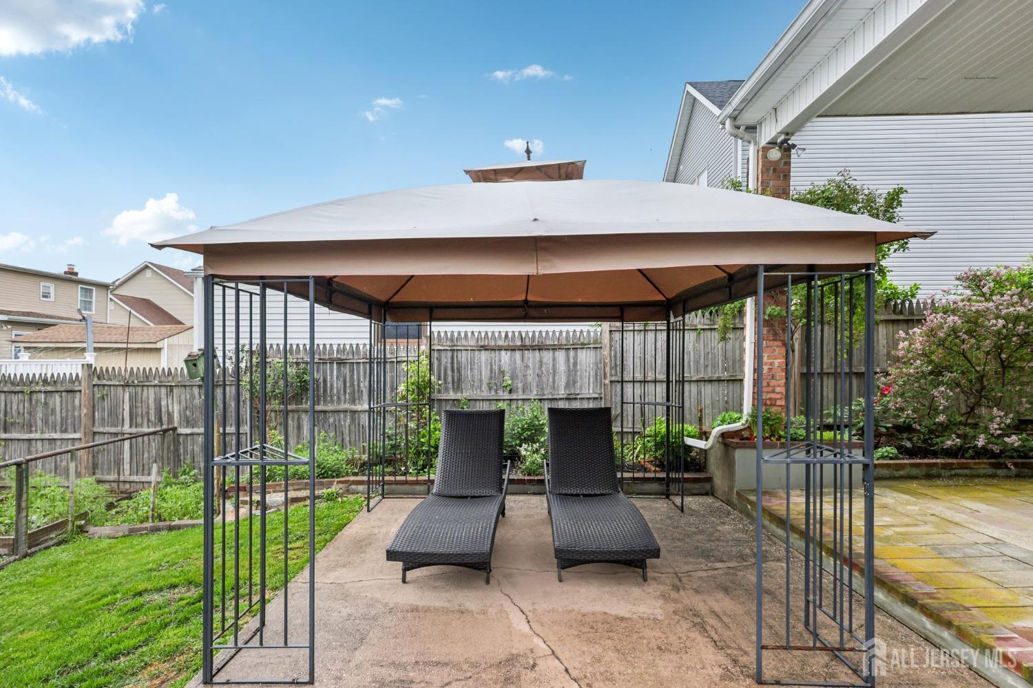 153 East Hill Road Colonia, NJ 07067 - Photo 27 of 40 a view of house with backyard outdoor seating and green space