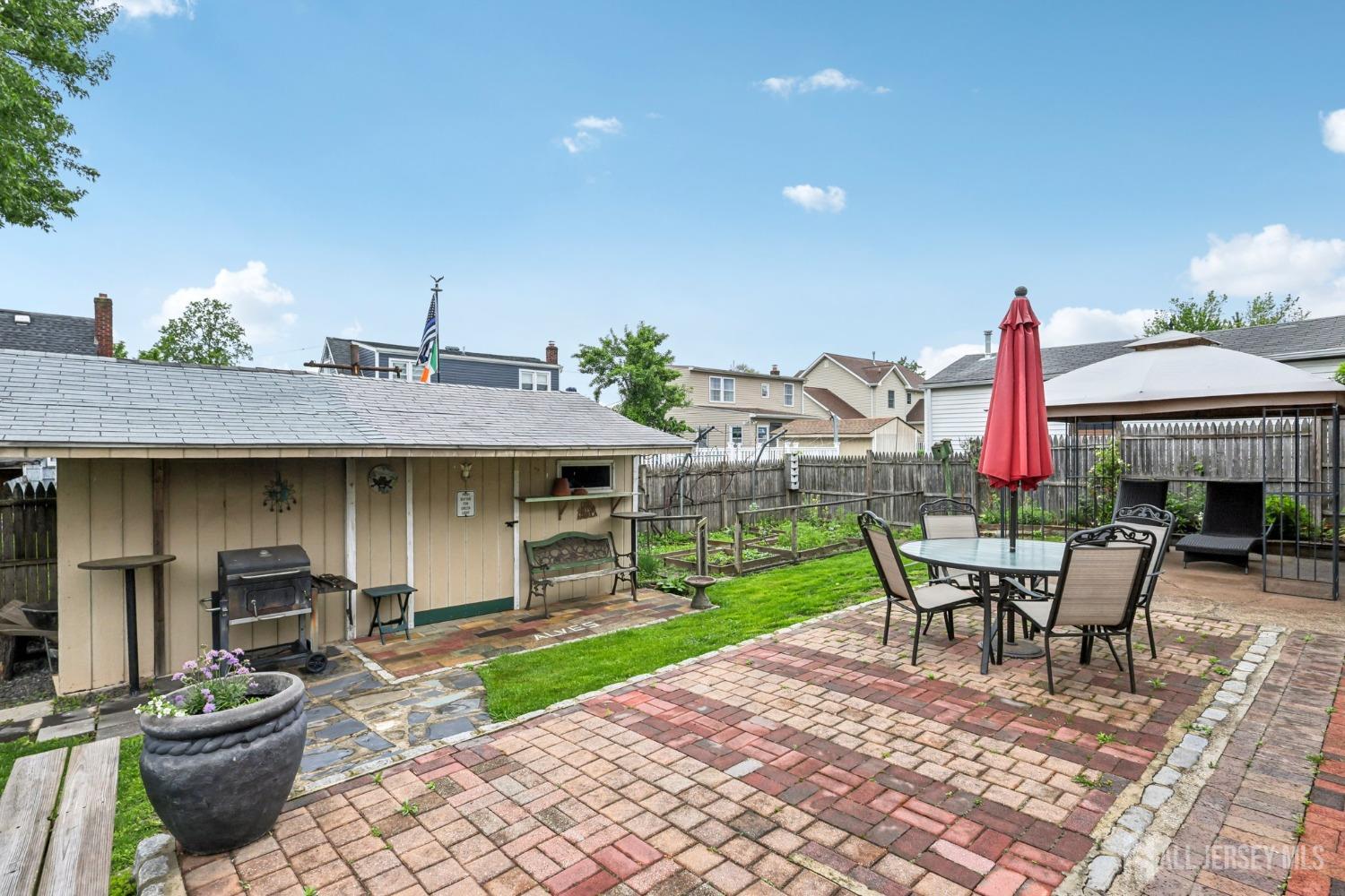 153 East Hill Road Colonia, NJ 07067 - Photo 28 of 40 a view of a patio with a table and chairs