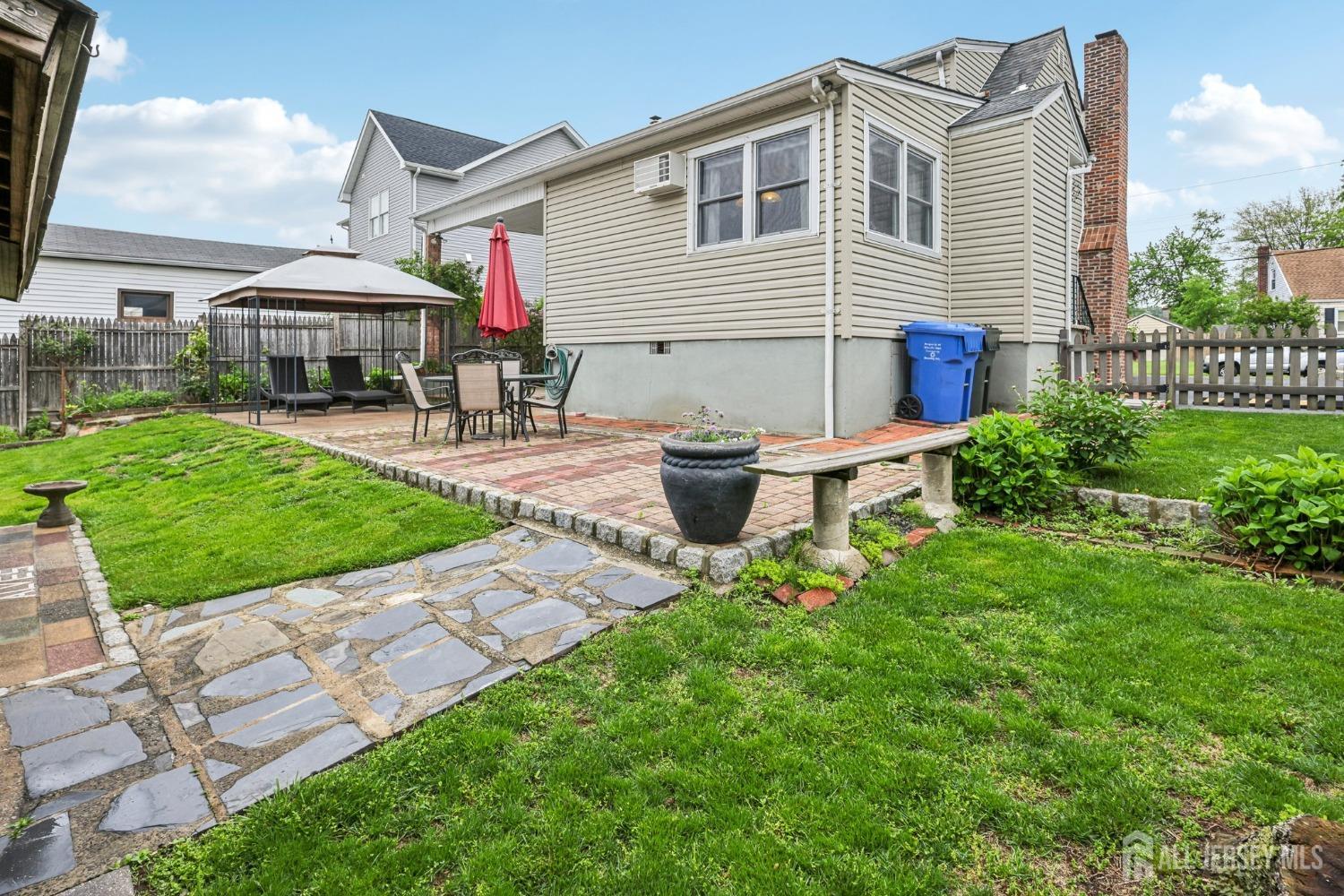 153 East Hill Road Colonia, NJ 07067 - Photo 29 of 40 a backyard of a house with table and chairs
