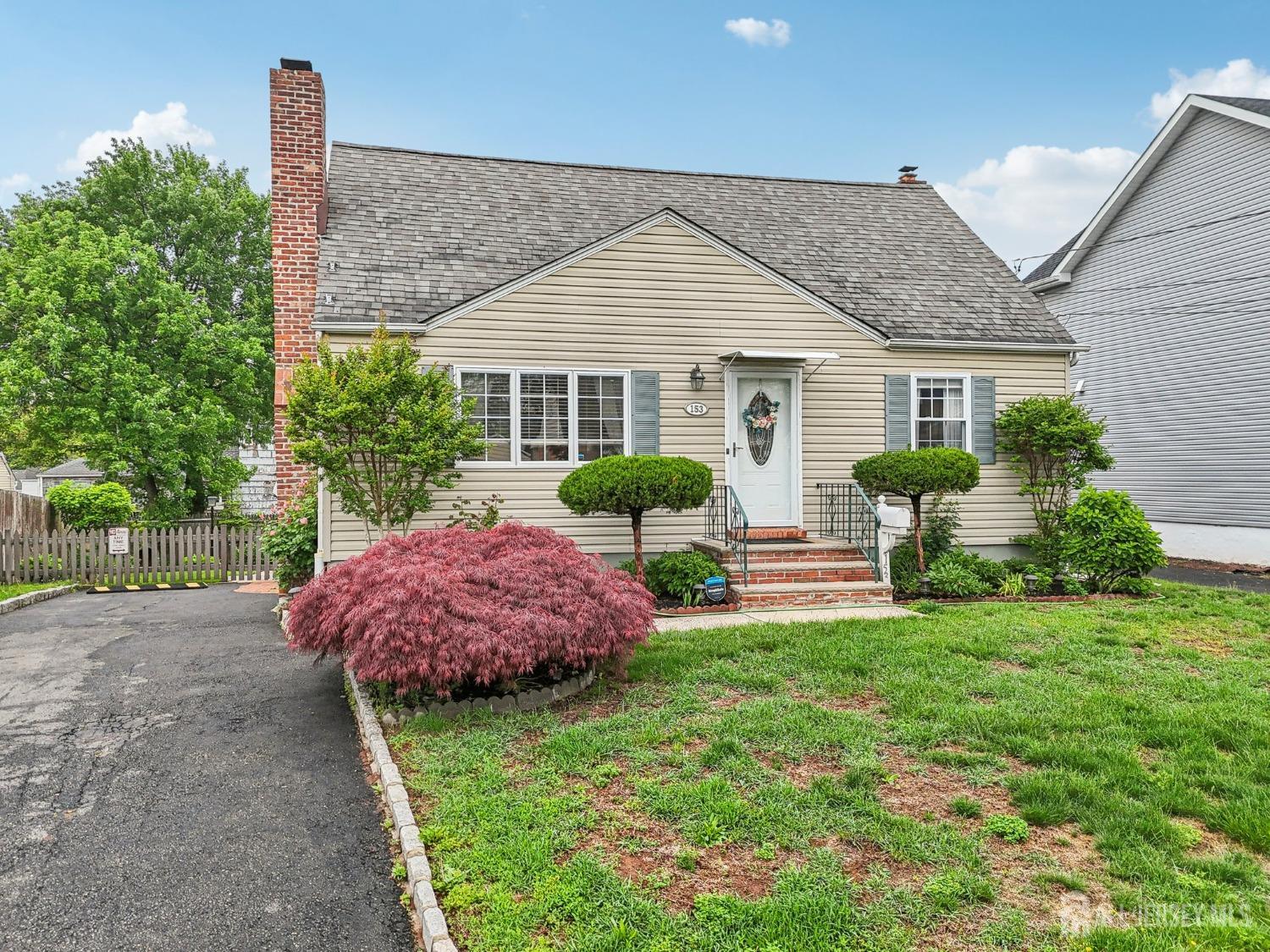 153 East Hill Road Colonia, NJ 07067 - Photo 33 of 40 a front view of house with yard and green space