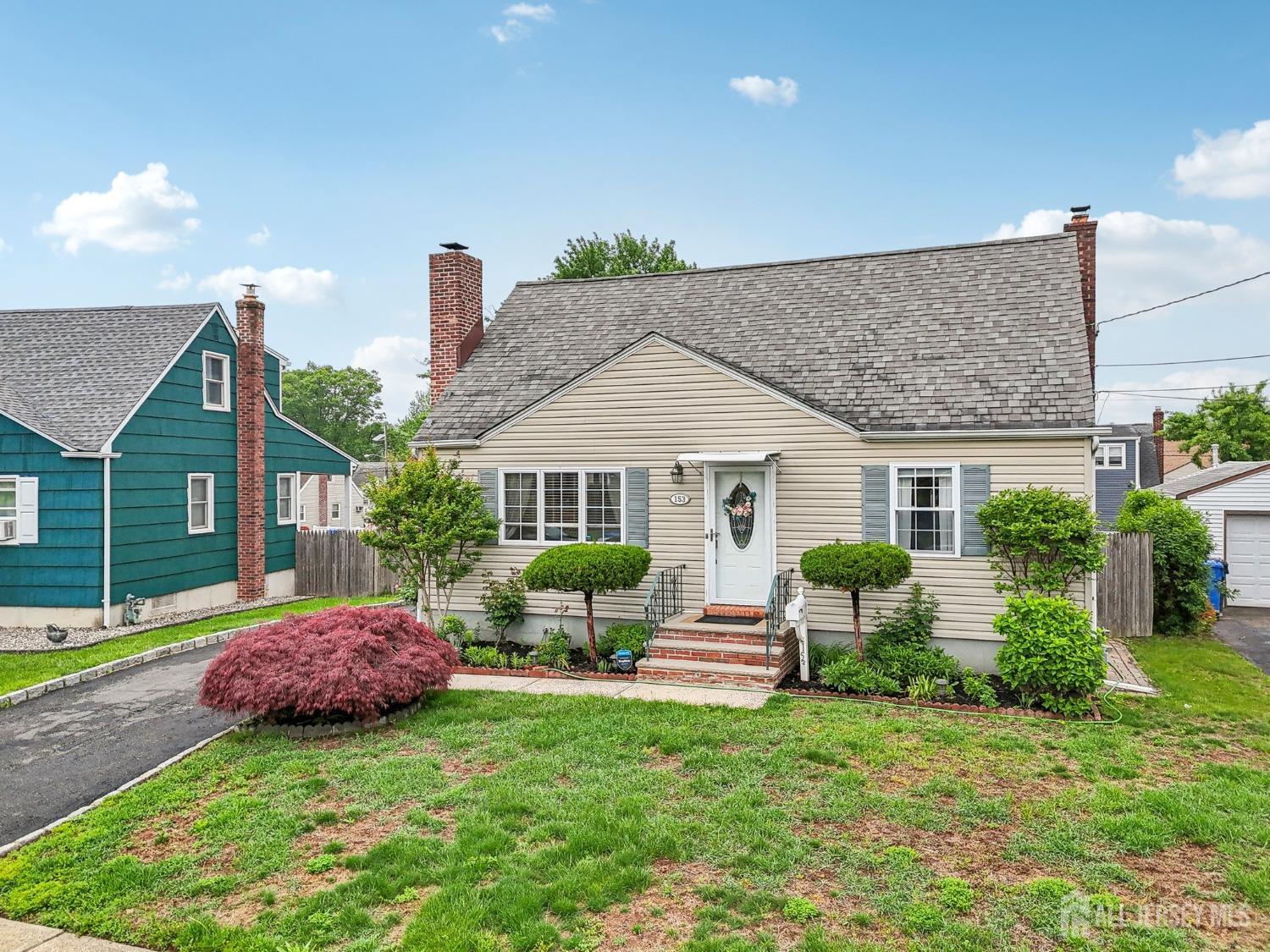 153 East Hill Road Colonia, NJ 07067 - Photo 34 of 40 a front view of house with yard and outdoor seating
