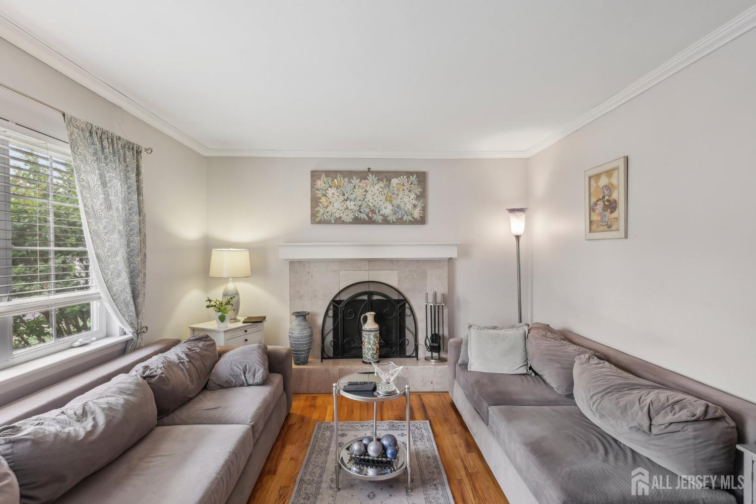 153 East Hill Road Colonia, NJ 07067 - Photo 4 of 40 a living room with furniture and a fireplace