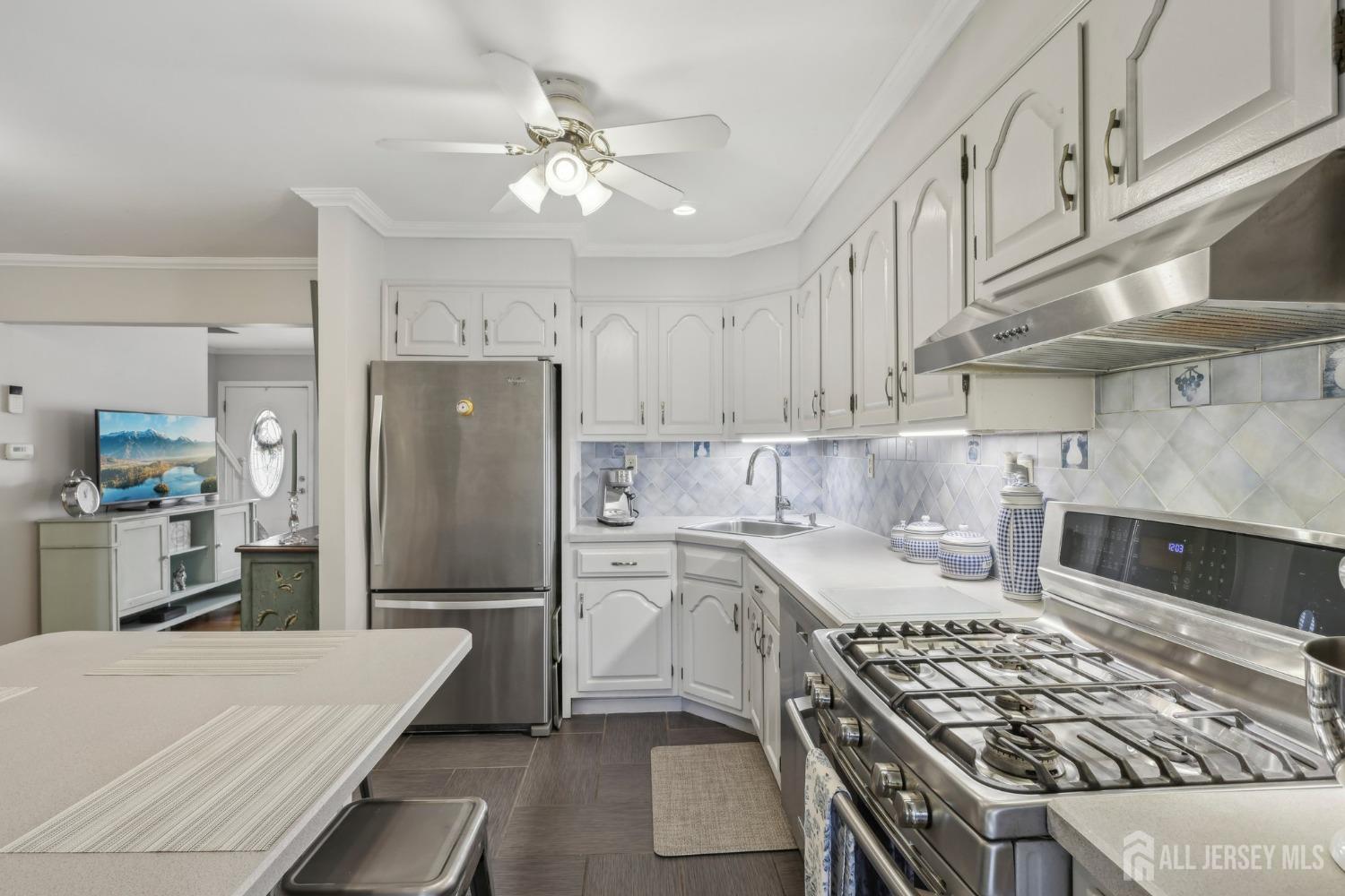 153 East Hill Road Colonia, NJ 07067 - Photo 8 of 40 a kitchen with kitchen island a sink stove and refrigerator