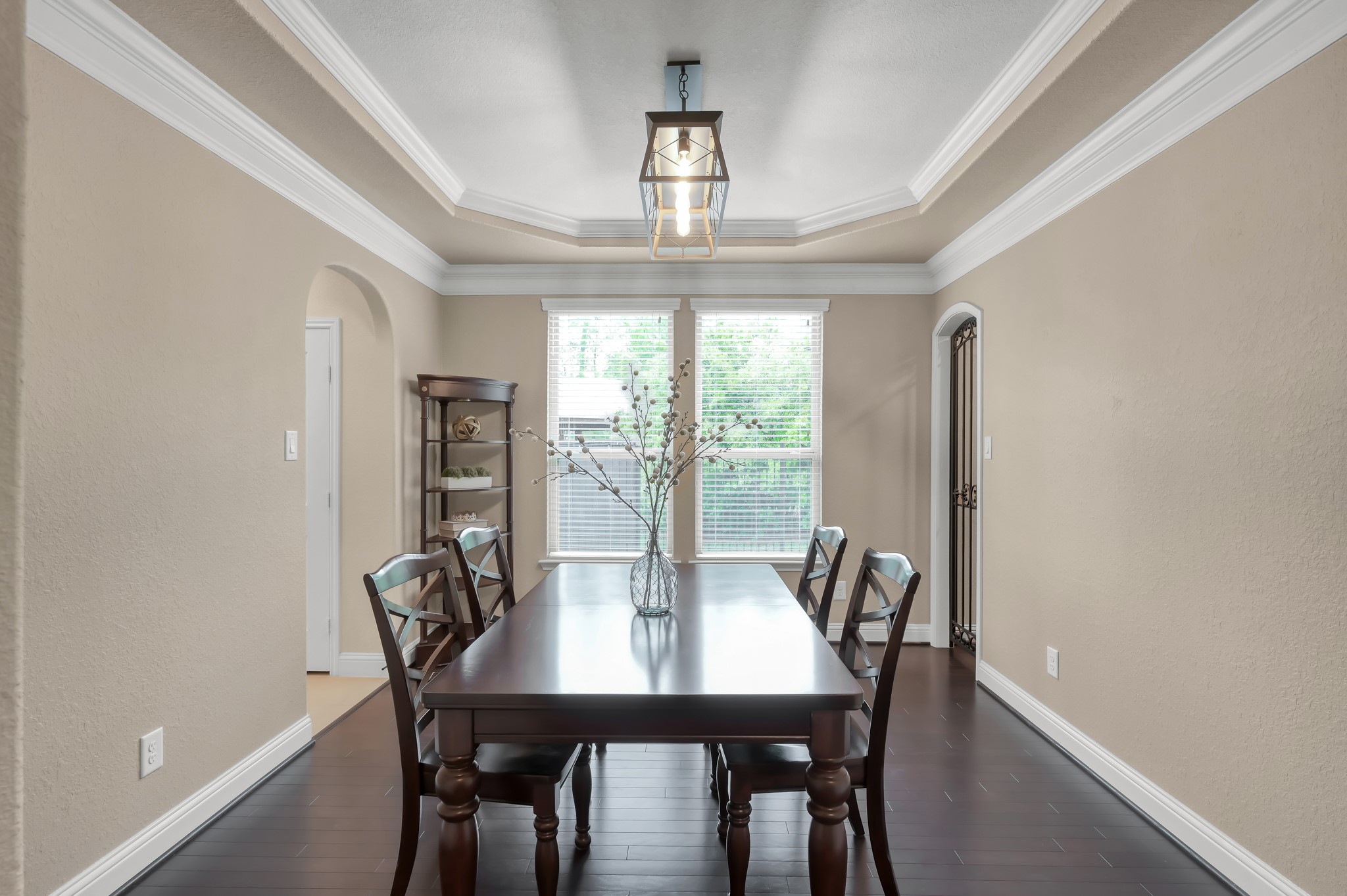23 Rancher's Trail Tomball, TX 77375 - Photo 18 of 40 Discover elegance in this formal dining space, complete with a charming wine cellar accentuated by a striking wrought iron gate.