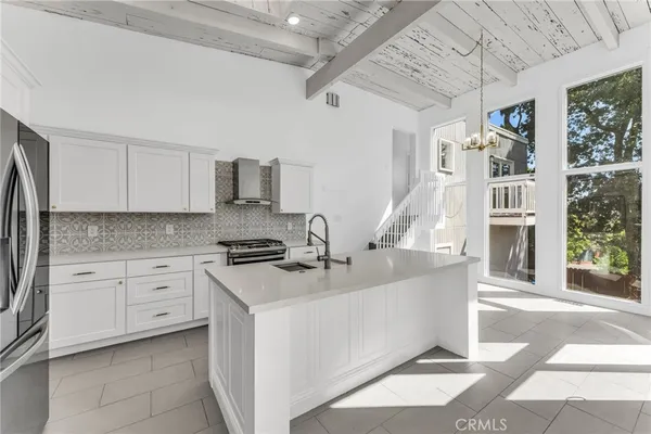 a kitchen with stainless steel appliances a stove a sink and a refrigerator