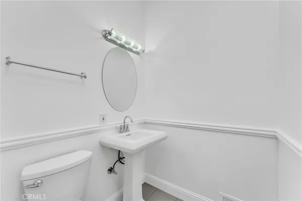 a bathroom with a granite countertop sink a toilet and shower