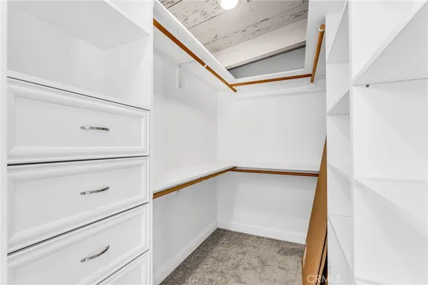 a bathroom with a granite countertop sink and a toilet
