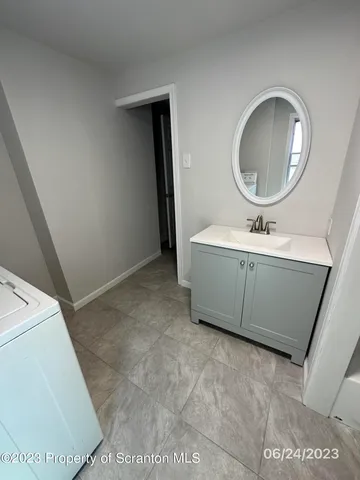 a bathroom with a sink mirror and toilet