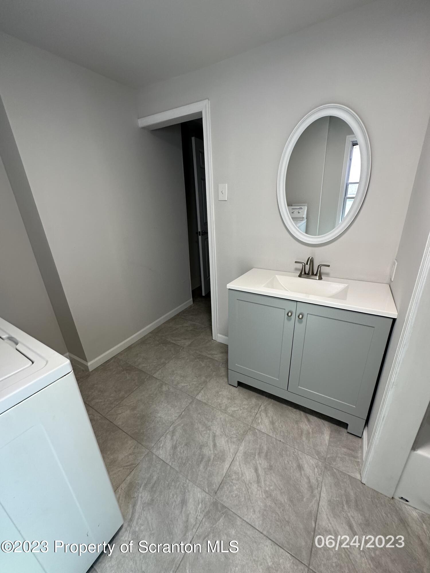 811 Eynon Street Scranton, PA 18504 - Photo 15 of 16 a bathroom with a sink mirror and toilet