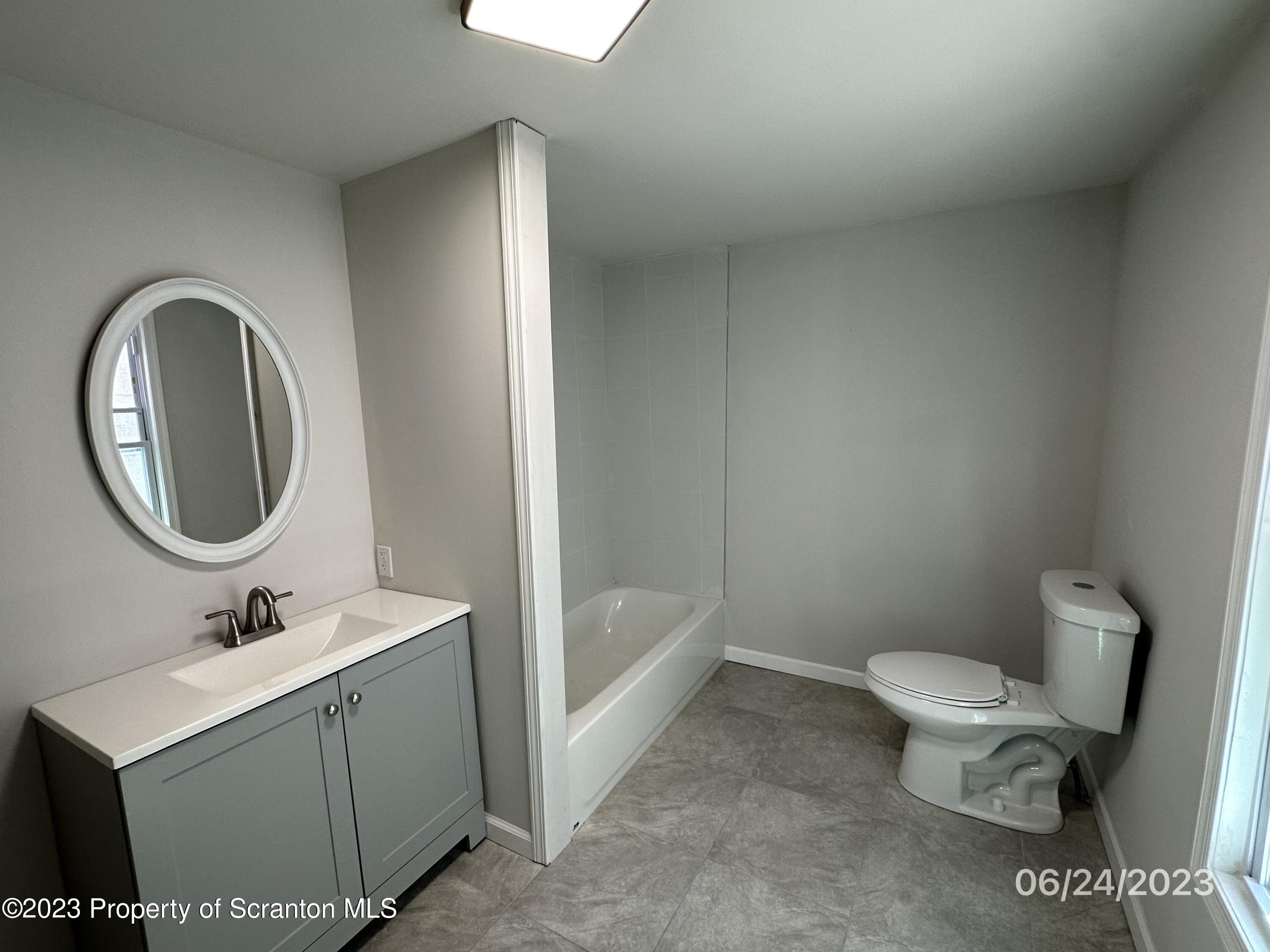 811 Eynon Street Scranton, PA 18504 - Photo 16 of 16 a bathroom with a sink toilet and a mirror