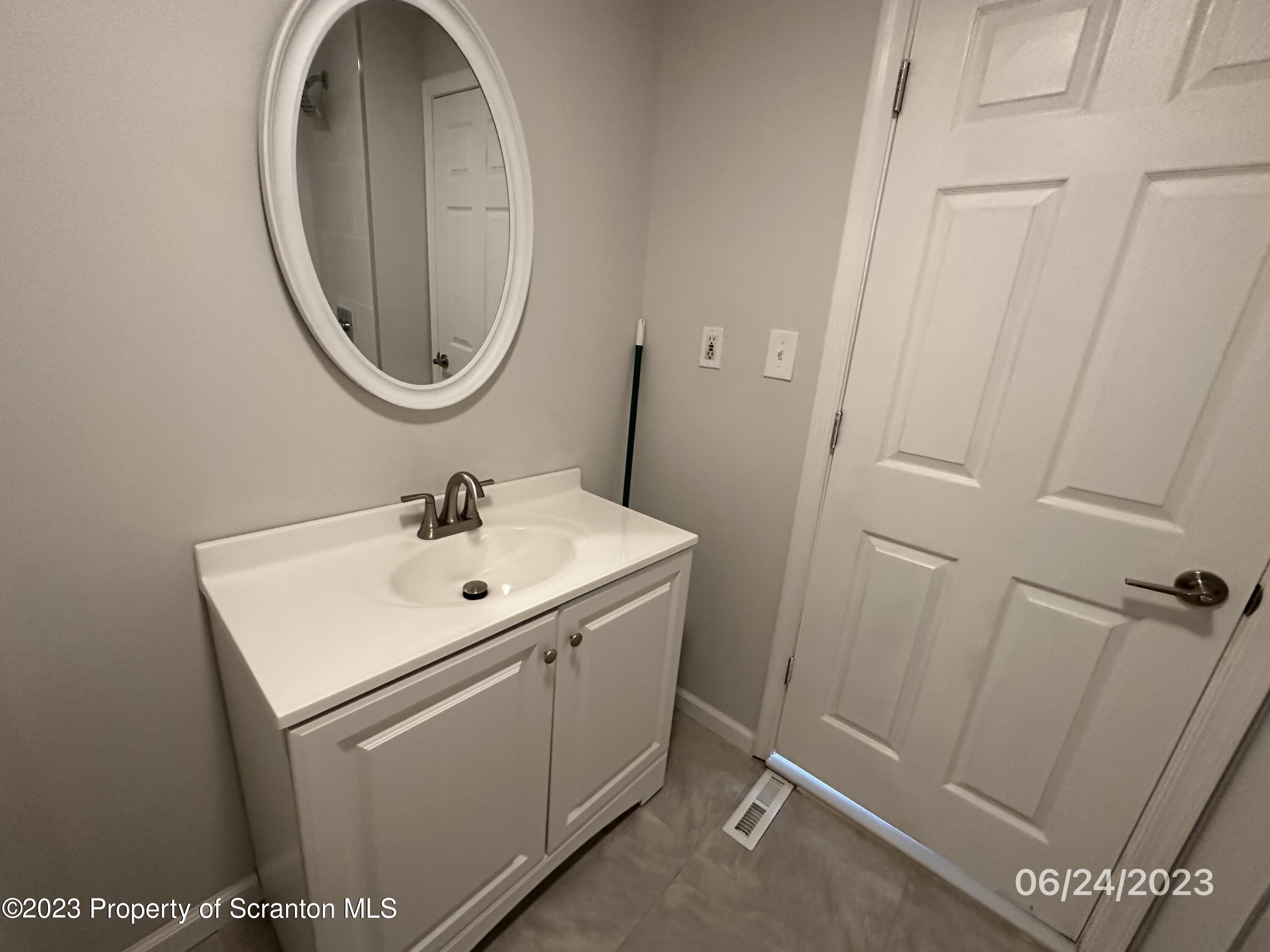 811 Eynon Street Scranton, PA 18504 - Photo 6 of 16 a white sink sitting under a mirror