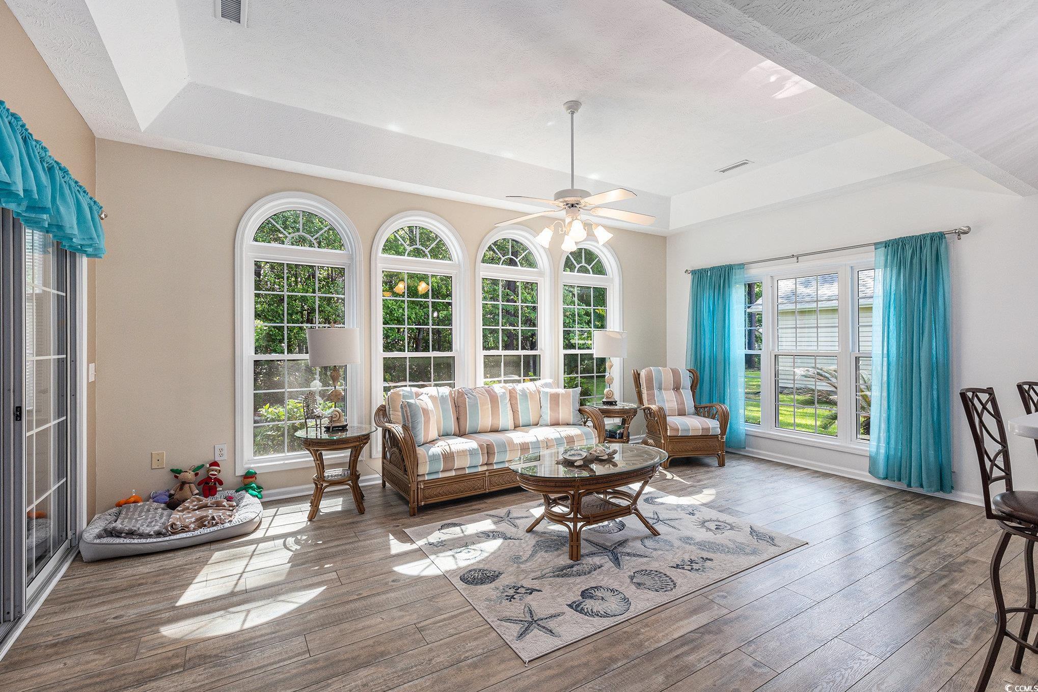 1105 Lampwick Lane Murrells Inlet, SC 29576 - Photo 15 of 40 Living room featuring a raised ceiling, plenty of natural light, hardwood / wood-style floors, and ceiling fan