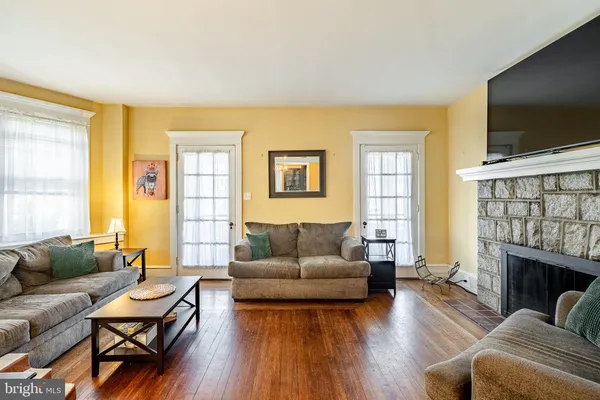 a living room with fireplace furniture and a flat screen tv
