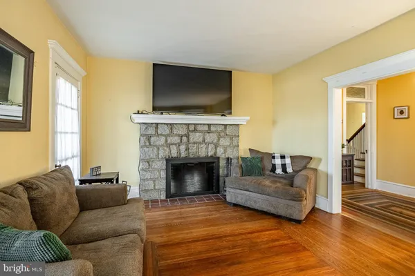 a living room with furniture flat screen tv and a fireplace