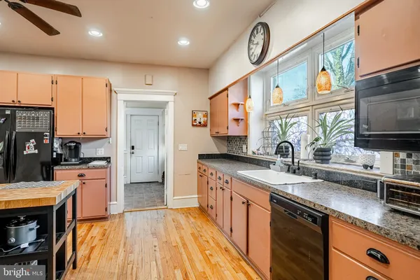 a kitchen with stainless steel appliances granite countertop a sink and cabinets