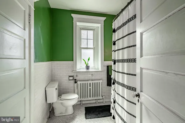 a bathroom with a toilet a sink and a window