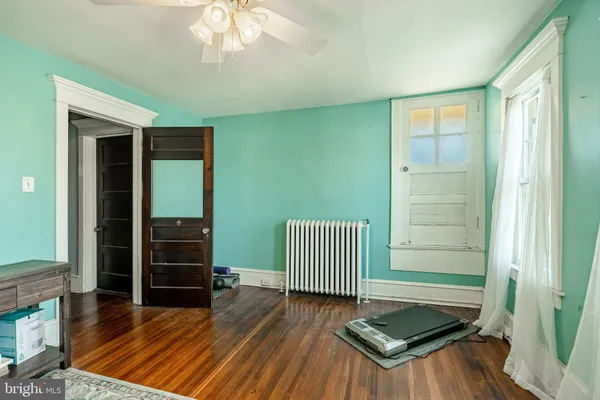 a view of a room with wooden floor and stairs