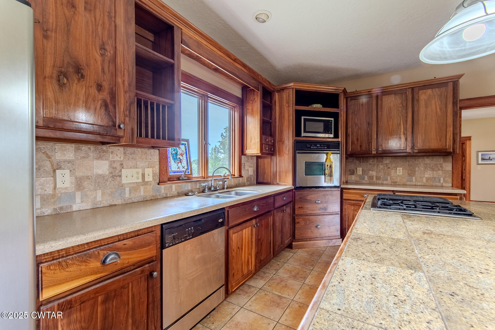 3554 Shades Bridge Road Greenfield, TN 38230 - Photo 9 of 49 a kitchen with stainless steel appliances granite countertop a stove a sink and a refrigerator