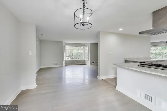 a view of a kitchen with a sink a refrigerator and window