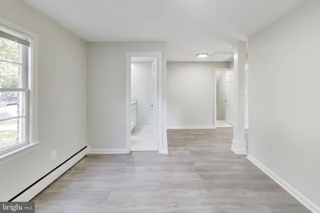 wooden floor in an empty room with a window