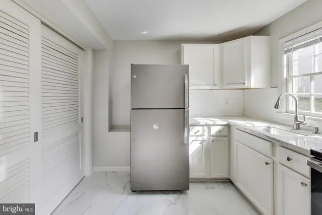 a utility room with cabinets washer and dryer