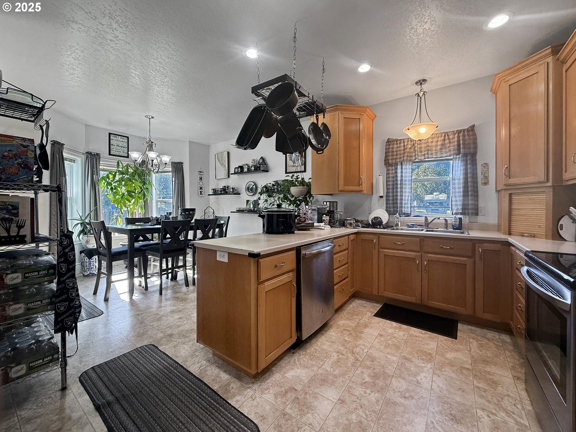 731 3rd Street, Unit C / 3 Brookings, OR 97415 - Photo 15 of 42 a kitchen with stainless steel appliances granite countertop a stove a sink a refrigerator and chairs