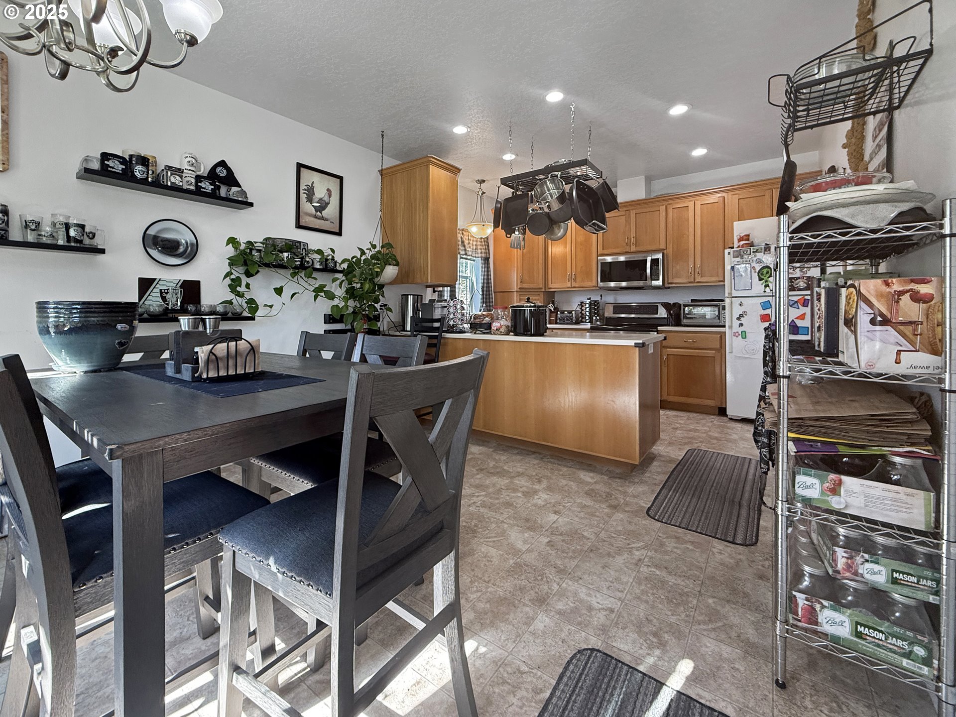731 3rd Street, Unit C / 3 Brookings, OR 97415 - Photo 20 of 42 a kitchen with stainless steel appliances granite countertop a stove top oven a sink a dining table and chairs with wooden floor
