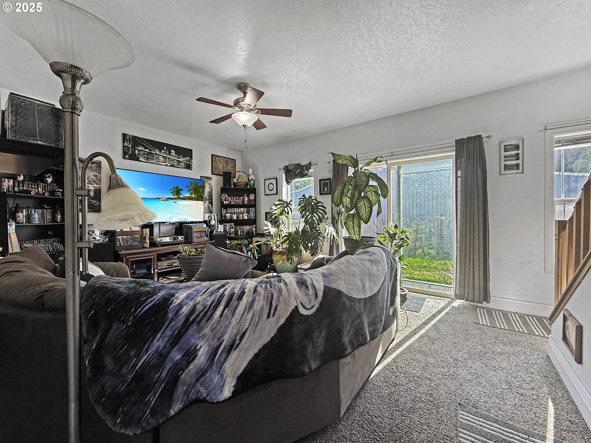 731 3rd Street, Unit C / 3 Brookings, OR 97415 - Photo 22 of 42 a living room with furniture a chandelier and a flat screen tv