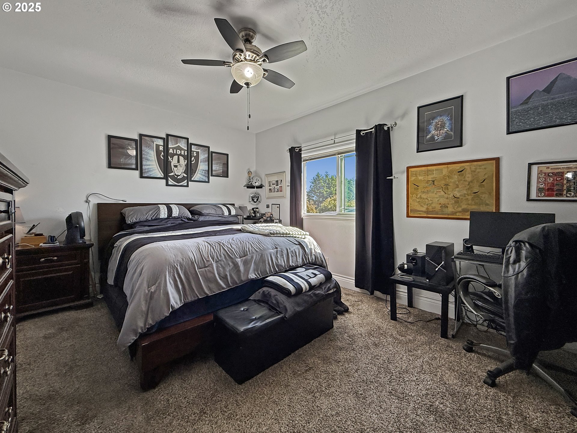731 3rd Street, Unit C / 3 Brookings, OR 97415 - Photo 25 of 42 a bedroom with a bed a couch and a chandelier