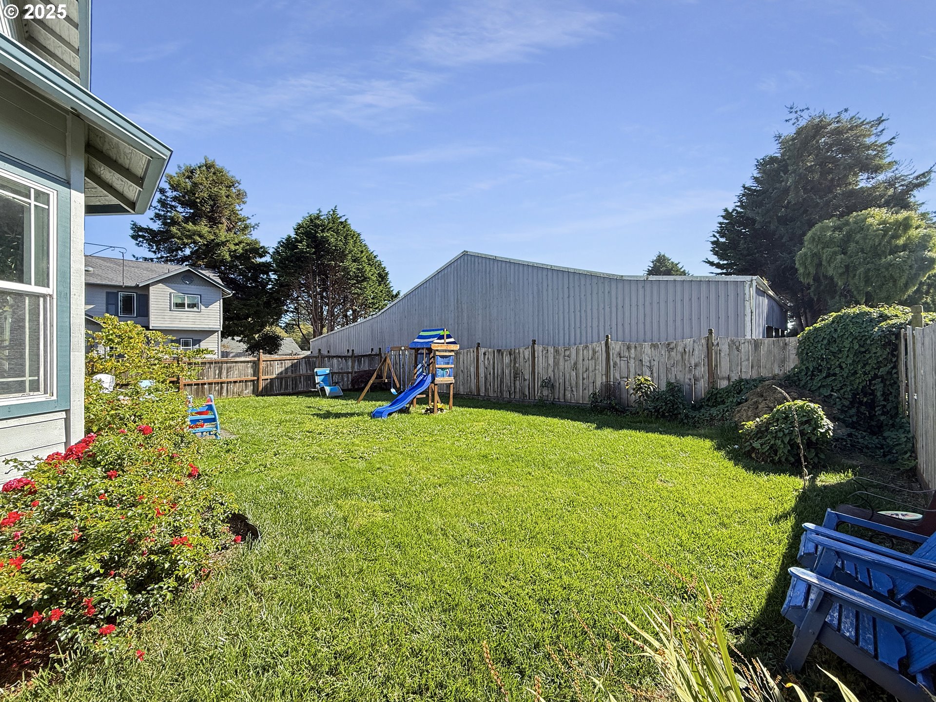 731 3rd Street, Unit C / 3 Brookings, OR 97415 - Photo 8 of 42 a view of a back yard with flower plants and wooden fence
