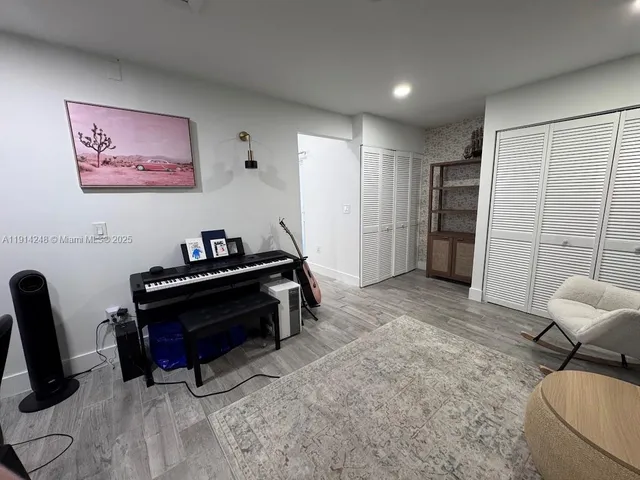 a living room with furniture and a piano