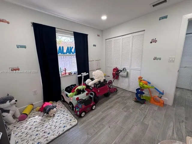 a living room with baby toys and wooden floor