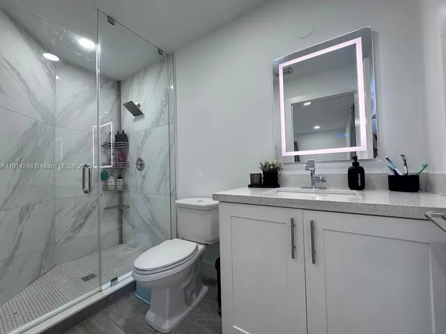 a bathroom with a sink toilet and shower