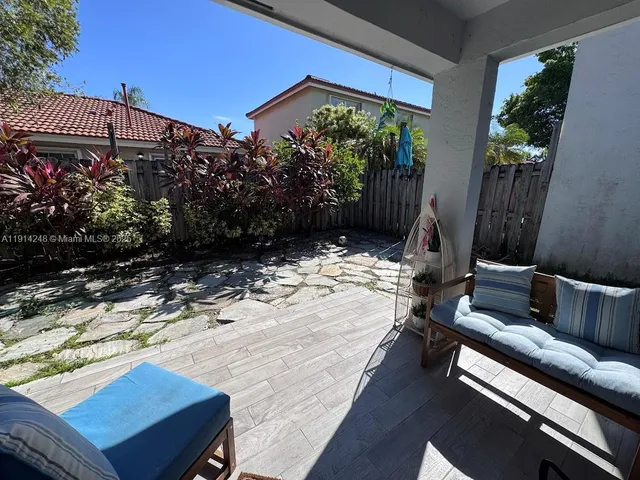 a view of a backyard with sitting area
