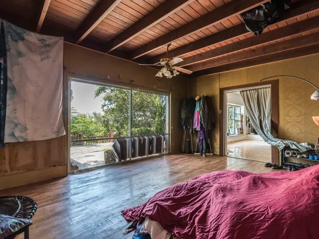 a bed room with a bed and a television