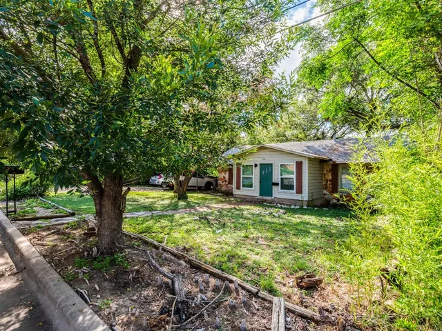 a yellow house in middle of the forest