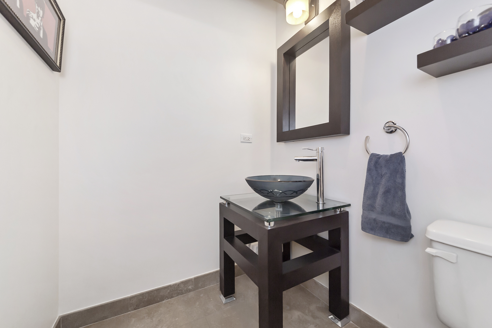 1000 West Washington Boulevard, Unit 142 Chicago, IL 60607 - Photo 12 of 24 a bathroom with a toilet a sink and a mirror