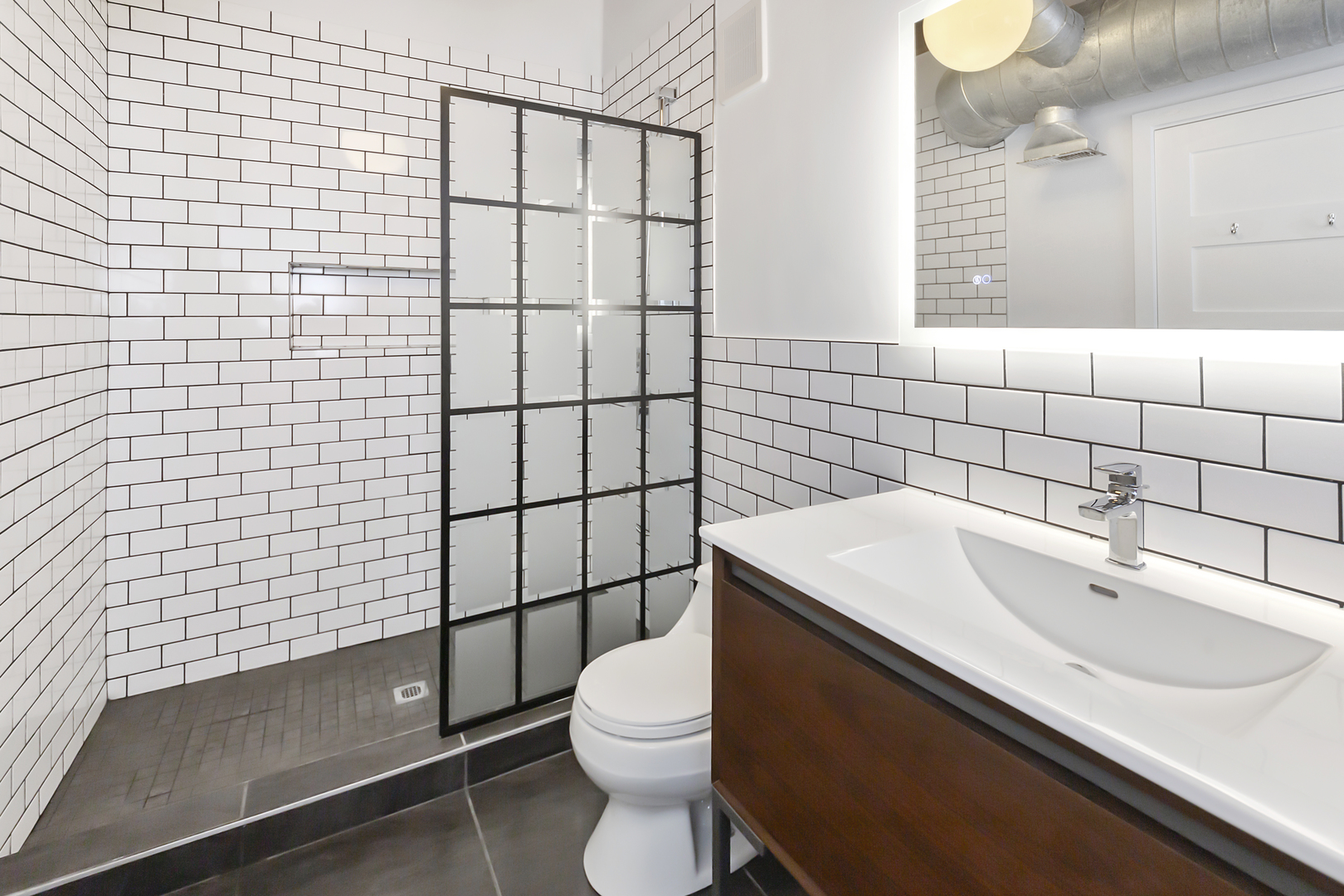 1000 West Washington Boulevard, Unit 142 Chicago, IL 60607 - Photo 19 of 24 a bathroom with a sink toilet and shower