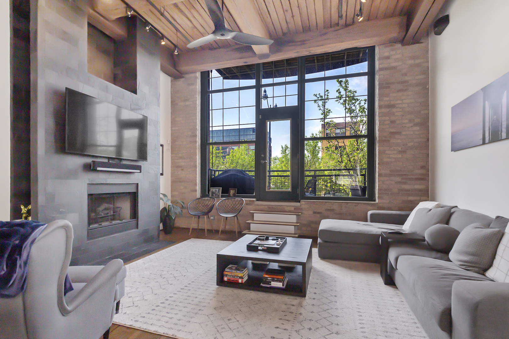 1000 West Washington Boulevard, Unit 142 Chicago, IL 60607 - Photo 3 of 24 a living room with furniture a fireplace and a flat screen tv