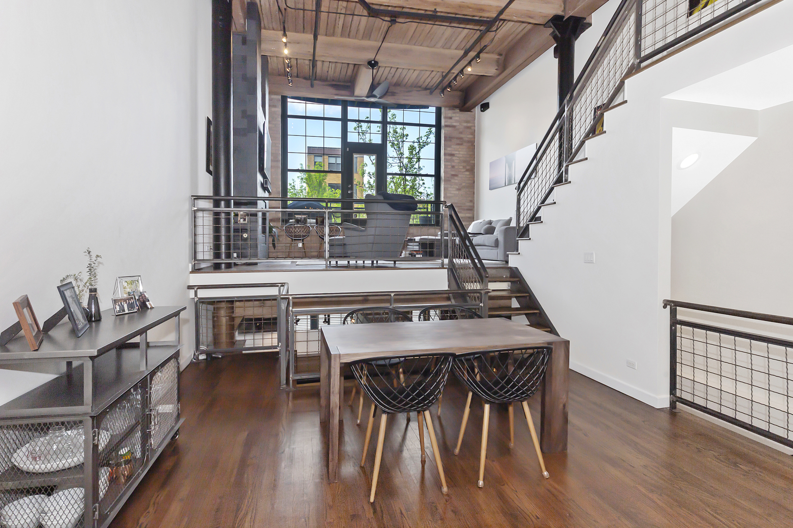 1000 West Washington Boulevard, Unit 142 Chicago, IL 60607 - Photo 6 of 24 a view of a dining room with furniture window and wooden floor