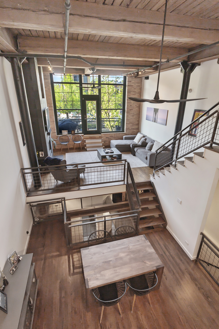 1000 West Washington Boulevard, Unit 142 Chicago, IL 60607 - Photo 8 of 24 a view of a kitchen with furniture wooden floor and a rug
