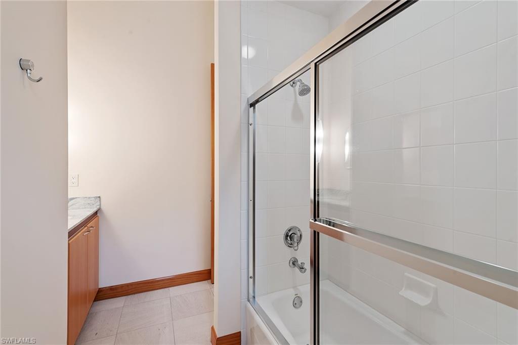 550 Starboard Drive Naples, FL 34103 - Photo 14 of 28 a bathroom with a glass shower door