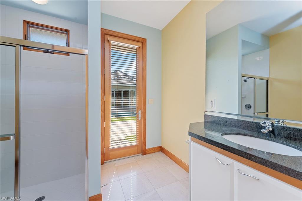 550 Starboard Drive Naples, FL 34103 - Photo 15 of 28 a bathroom with a granite countertop sink and a mirror