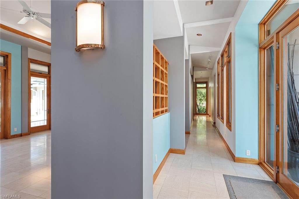 550 Starboard Drive Naples, FL 34103 - Photo 21 of 28 a view of a hallway with wooden floor and windows