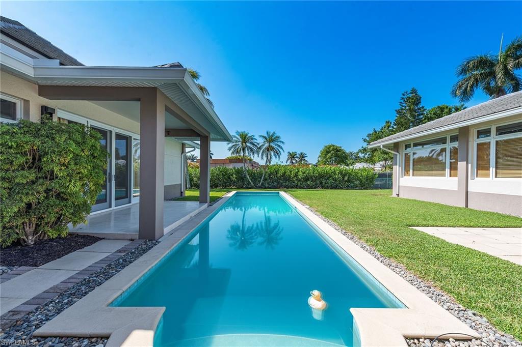 550 Starboard Drive Naples, FL 34103 - Photo 23 of 28 a view of a house with a yard
